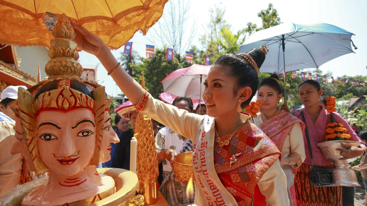 Laos president calls on people to overcome challenges